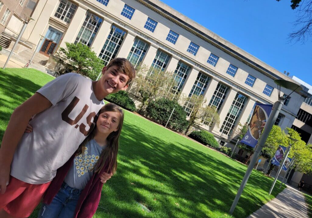 Alex and Katie standing on the MIT campus during a college visit, symbolizing the rewards of intentional, educationally focused parenting.